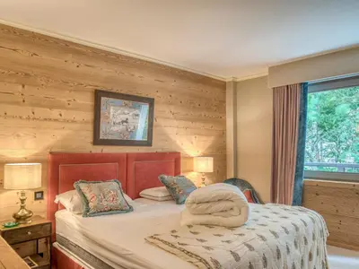 a bedroom with a bed and a window at Confortable Appartement 3 Chambres au Centre de Megève avec Wifi - FR-1-453-100 in Megève
