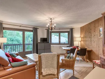a living room with a couch and a table at Appartement 2 Chambres Megève, Balcon Sud, Parking, Wifi - FR-1-453-101 in Megève