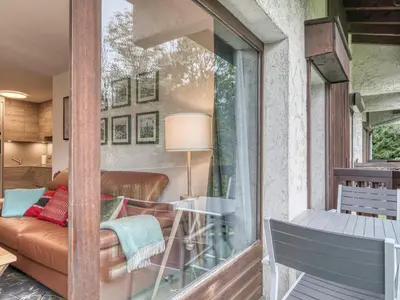 a balcony with a couch and a table at Appartement 2 Chambres Megève, Balcon Sud, Parking, Wifi - FR-1-453-101 in Megève