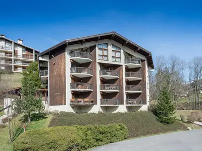 a building with balconies on the side of it at Appartement 2 Chambres Megève, Balcon Sud, Parking, Wifi - FR-1-453-101 in Megève