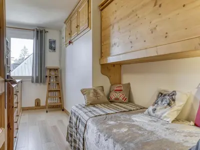 a small bedroom with a bed and a loft at Appartement 2 chambres en centre-ville à Megève avec balcon et wifi - FR-1-453-107 in Megève