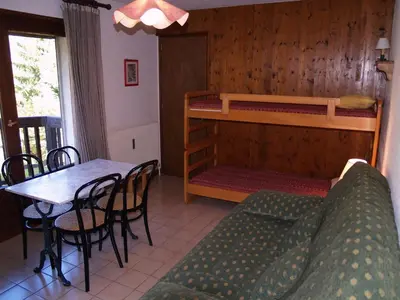 a living room with a couch and a table and a bunk bed at Studio à Megève - 3 personnes, Animaux admis - FR-1-453-116 in Megève