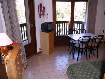 a living room with a table and chairs and a television at Studio à Megève - 3 personnes, Animaux admis - FR-1-453-116 in Megève