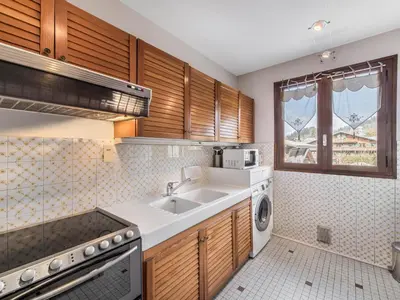 a kitchen with a sink and a dishwasher at Appartement 2 pièces au cœur de Megève avec balcon et parking - FR-1-453-118 in Megève