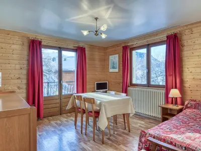 a dining room with a table and red curtains at Appartement 2 pièces avec balcon et parking à Megève - FR-1-453-120 in Megève
