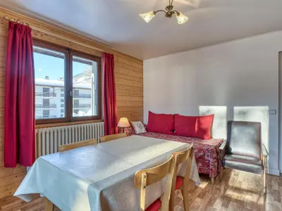 a bedroom with a large bed and a window at Appartement 2 pièces avec balcon et parking à Megève - FR-1-453-120 in Megève