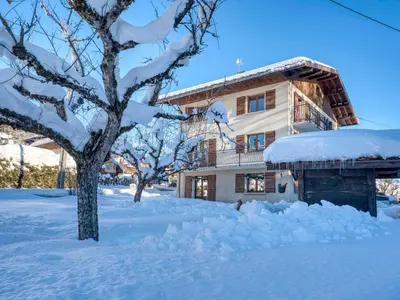 a house covered in snow next to a tree at Appartement cosy 1 chambre à Megève avec WiFi et parking - FR-1-453-122 in Megève