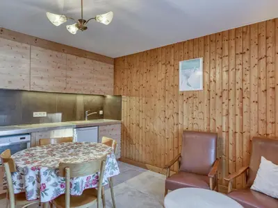 a kitchen with a table and chairs in a room at Appartement cosy 1 chambre à Megève avec WiFi et parking - FR-1-453-122 in Megève