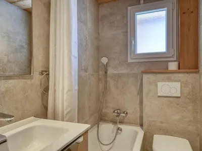 a bathroom with a sink and a toilet and a window at Appartement cosy 1 chambre à Megève avec WiFi et parking - FR-1-453-122 in Megève