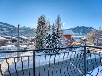 a balcony with a snow covered christmas tree at Appartement cosy 1 chambre à Megève avec WiFi et parking - FR-1-453-122 in Megève