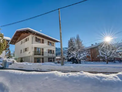 a building in the snow in front of a building at Appartement cosy 1 chambre à Megève avec WiFi et parking - FR-1-453-122 in Megève