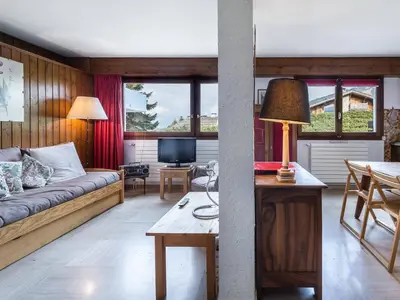 a living room with a couch and a table at Studio à Megève Rochebrune, à 10 min du centre, pour 2 personnes - FR-1-453-124 in Megève