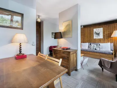 a room with a dining table and a bed at Studio à Megève Rochebrune, à 10 min du centre, pour 2 personnes - FR-1-453-124 in Megève