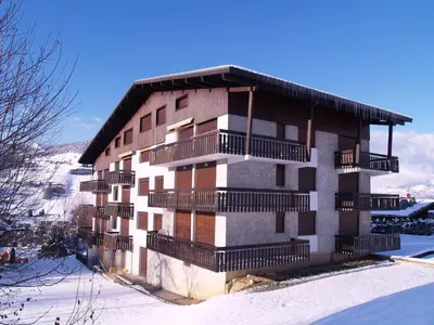 a building with balconies on it in the snow at Studio à Megève Rochebrune, à 10 min du centre, pour 2 personnes - FR-1-453-124 in Megève