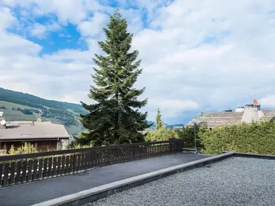 a pine tree on the side of a fence at Studio à Megève Rochebrune, à 10 min du centre, pour 2 personnes - FR-1-453-124 in Megève