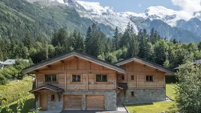 an aerial view of a house with mountains in the background at Chalet Chal'heureux in Chamonix-Mont-Blanc