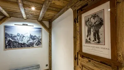 a hallway with a picture of a skier on the wall at Chalet Chal'heureux + Annexe in Chamonix-Mont-Blanc