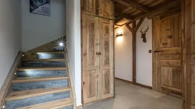 a staircase with wooden doors in a room at Chalet Chal'heureux + Annexe in Chamonix-Mont-Blanc