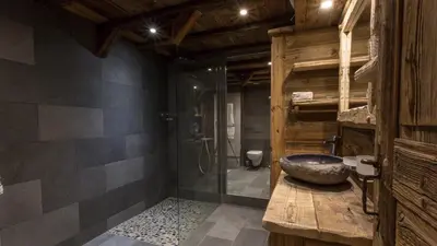 a bathroom with a stone sink and a shower at Chalet Chal'heureux + Annexe in Chamonix-Mont-Blanc