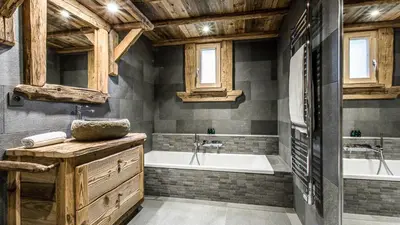 a bathroom with a tub and a sink and a tub and a bath tub at Chalet Chal'heureux + Annexe in Chamonix-Mont-Blanc