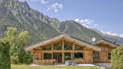 a log cabin with snow on the roof at Chalet Chal'heureux + Annexe in Chamonix-Mont-Blanc