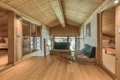 a living room with a couch and a chair at Brévent Loft Cozy 3-bedroom duplex 250m to Planpraz cable car in Chamonix-Mont-Blanc