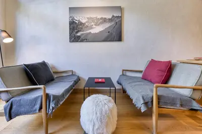 a living room with two couches and a table at Brévent Loft Cozy 3-bedroom duplex 250m to Planpraz cable car in Chamonix-Mont-Blanc