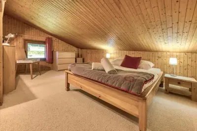 a bedroom with a bed with a wooden ceiling at Brévent Loft Cozy 3-bedroom duplex 250m to Planpraz cable car in Chamonix-Mont-Blanc