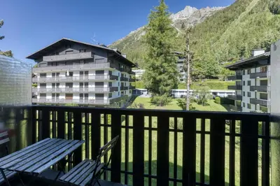 a balcony with a bench and a building at Brévent Loft Cozy 3-bedroom duplex 250m to Planpraz cable car in Chamonix-Mont-Blanc