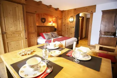 a swimming pool with lounge chairs and a mountain at Residence Hôtelière La Renardiere in Samoëns