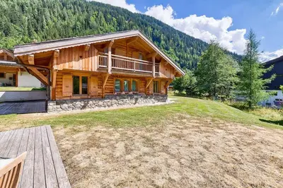 a large log cabin with a large yard at Chalet Coralie in Chamonix-Mont-Blanc