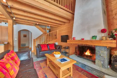 a living room with a fireplace and a couch at Chalet Coralie in Chamonix-Mont-Blanc