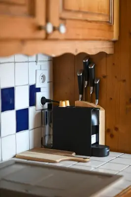 a kitchen counter with a coffee maker and utensils at La Ginabelle Chamonix in Chamonix-Mont-Blanc