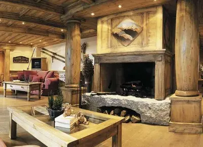 a living room with a fireplace and a couch at La Ginabelle Chamonix in Chamonix-Mont-Blanc