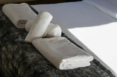 a group of rolled up towels on a bed at La Ginabelle Chamonix in Chamonix-Mont-Blanc