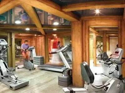 a gym with several tread machines and people in it at La Ginabelle Chamonix in Chamonix-Mont-Blanc