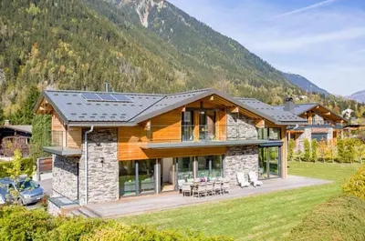 a house with a solar roof on a mountain at Chalet Montana- Chamonix All Year in Chamonix-Mont-Blanc