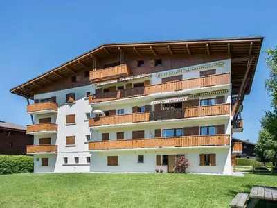 a large white building with a black roof at Bel appartement 3 pièces, 2 chambres, parking, Megeve Jaillet - FR-1-453-126 in Megève