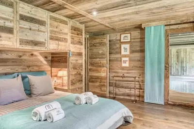 a bedroom with a bed with towels on it at Chalet Javen - 520m2 avec piscine chauffée et home cinéma in Megève