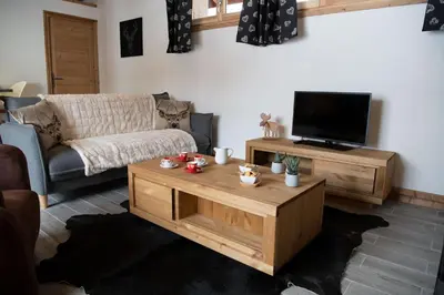 a living room with a couch and a coffee table at Chalet Victoire in Chamonix-Mont-Blanc
