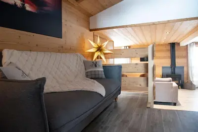 a living room with a couch and a fireplace at Chalet Victoire in Chamonix-Mont-Blanc