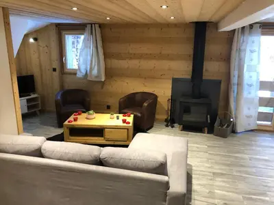 a living room with a couch and a fireplace at Chalet Victoire in Chamonix-Mont-Blanc