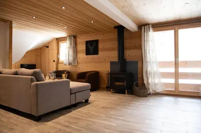 a living room with a couch and a stove at Chalet Victoire in Chamonix-Mont-Blanc