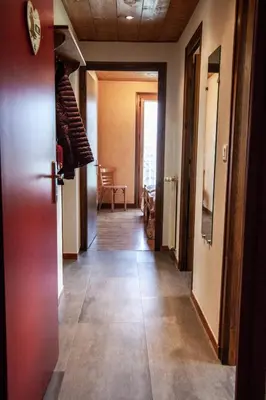 a hallway with a door open to a room at Appartements Giffre et Clesson - DAHU COMPAGNIE in Samoëns