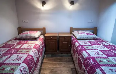 two beds sitting next to each other in a room at Appartements Giffre et Clesson - DAHU COMPAGNIE in Samoëns