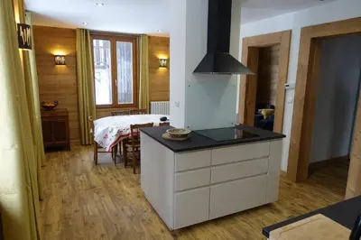 a kitchen with a island with a counter top at Chalet des glaciers in Chamonix-Mont-Blanc