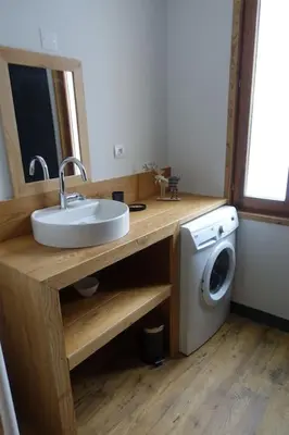 a bathroom with a sink and a washing machine at Chalet des glaciers in Chamonix-Mont-Blanc