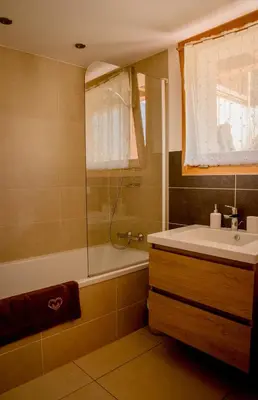 a bedroom with a bed and a dresser with a television at Apartment La Tibolire in Sixt