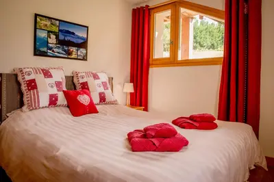 two beds in a room with two windows at Apartment La Tibolire in Sixt