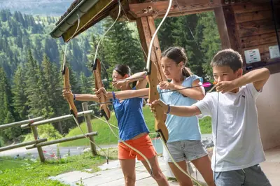 a group of children playing with a bow and arrow at Hôtel Club MMV Le Flaine in Flaine